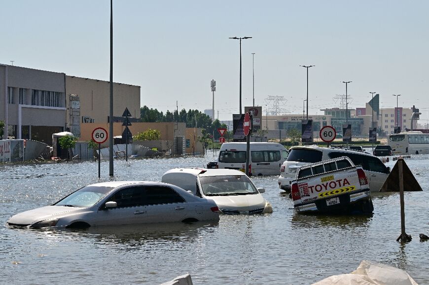 Waterlogged vehicles await recovery on a flooded Dubai highway