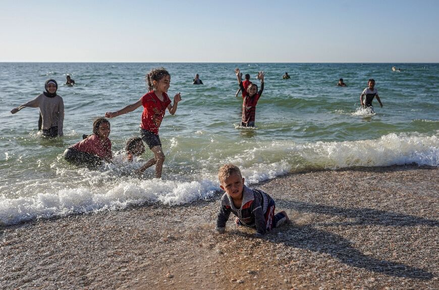 Palestinian children play on a beach in Deir el-Balah in the central Gaza Strip, despite the war in the Palestinian territory