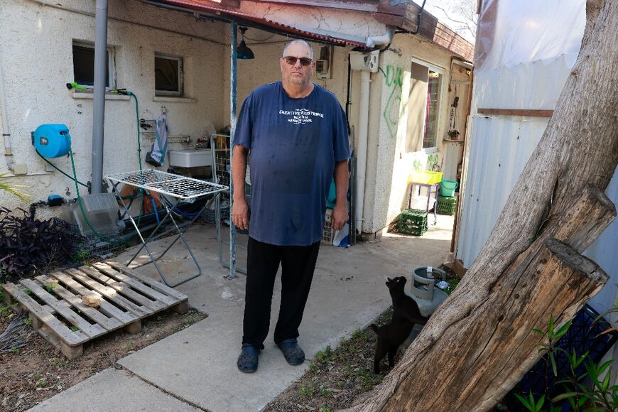 Shar Shnurman, the first survivor of the October 7 attack to have returned to this Israeli kibbutz, stands in front of his house