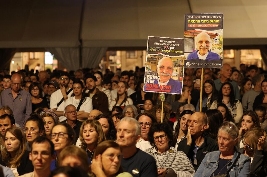 Israelis carry posters with images of hostages held in Gaza at a rally in Tel Aviv on Holocaust Remembrance Day