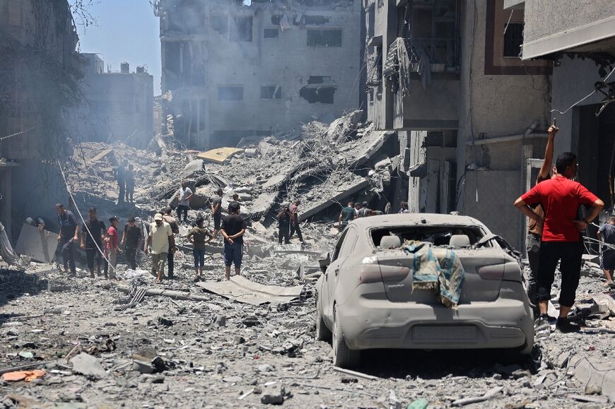 People inspect the damage after Israeli bombardment of the al-Shati refugee camp in Gaza City on June 22, 2024