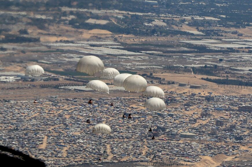 A handout picture released by the Jordanian army shows humanitarian aid being airdropped from a military aircraft over southern Gaza on June 25, 2024