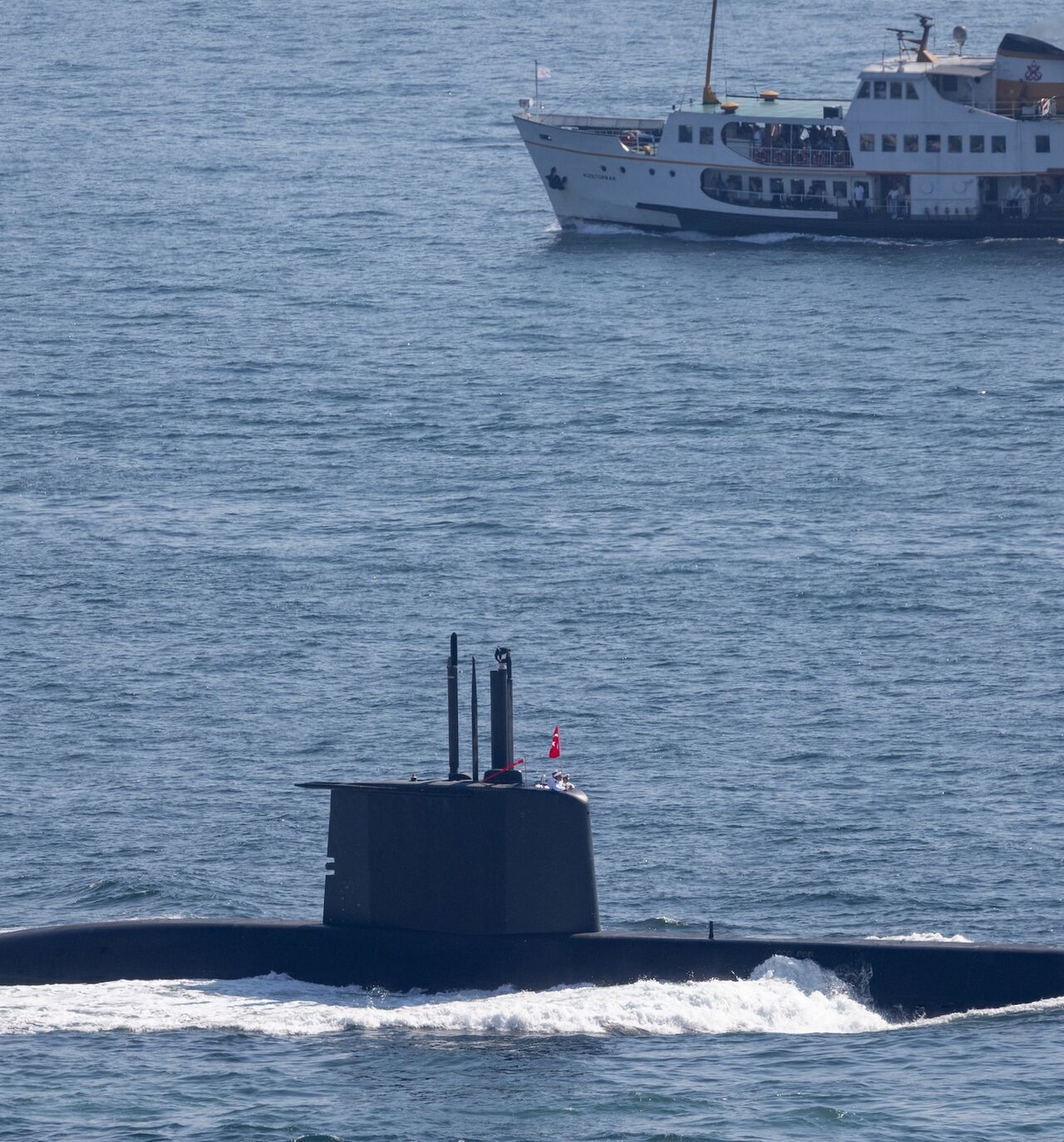 A ferry passes a Turkish Navy submarine navigating the Bosphorus on Sept. 27, 2024, in Istanbul, Turkey.
