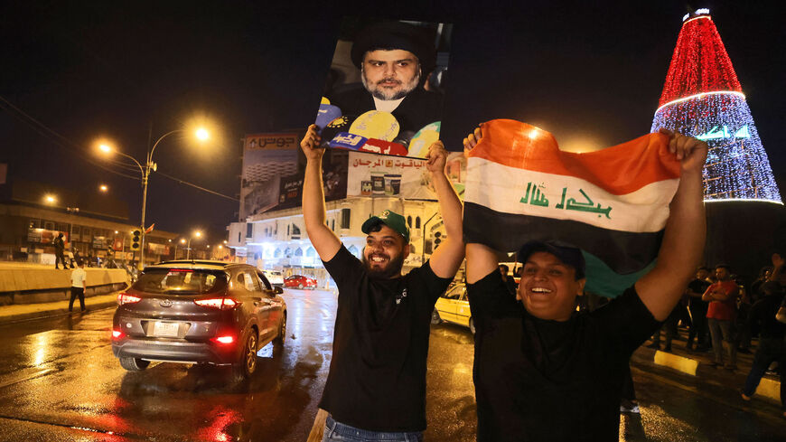 Supporters of Iraqi Shiite cleric Moqtada al-Sadr celebrate in Baghdad's Tahrir square on Oct. 11, 2021 following the announcement of parliamentary elections' results.