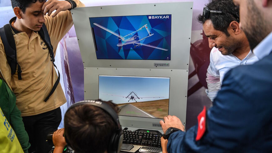 A Turkish boy uses a Turkish unmanned aircraft (ANKA) simulation unit on Sept. 20, 2018 at the Istanbul's new international airport, during the Teknofest aviation, space and technology fair. 