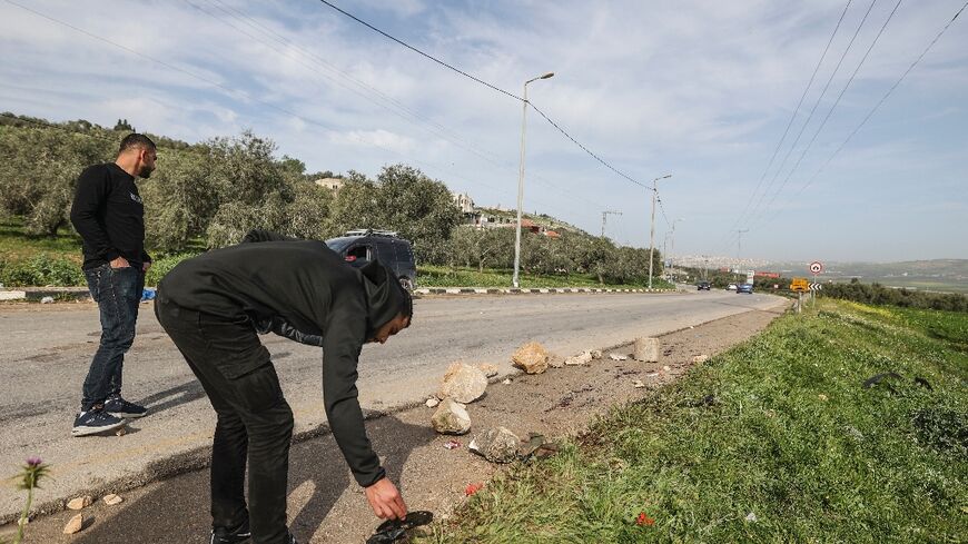 Palestinians inspect blood stains in the area where Israeli security forces killed three Islamic Jihad militants, near the northern West Bank city of Jenin