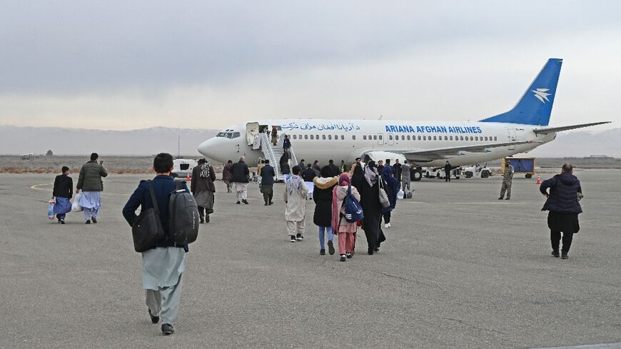 Afghan passengers board a commercial aircraft in February at Herat airport for a flight to Kabul