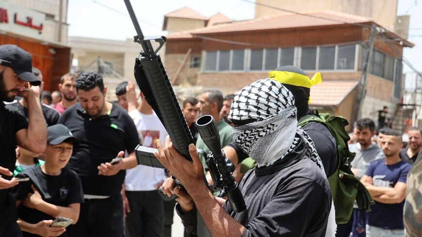 Members of the Palestinian Al-Aqsa Martyr's Brigades faction affiliated with the Fatah movement take part in the funeral of Yahya Adwan in his village of Azzun in the north of the occupied West Bank