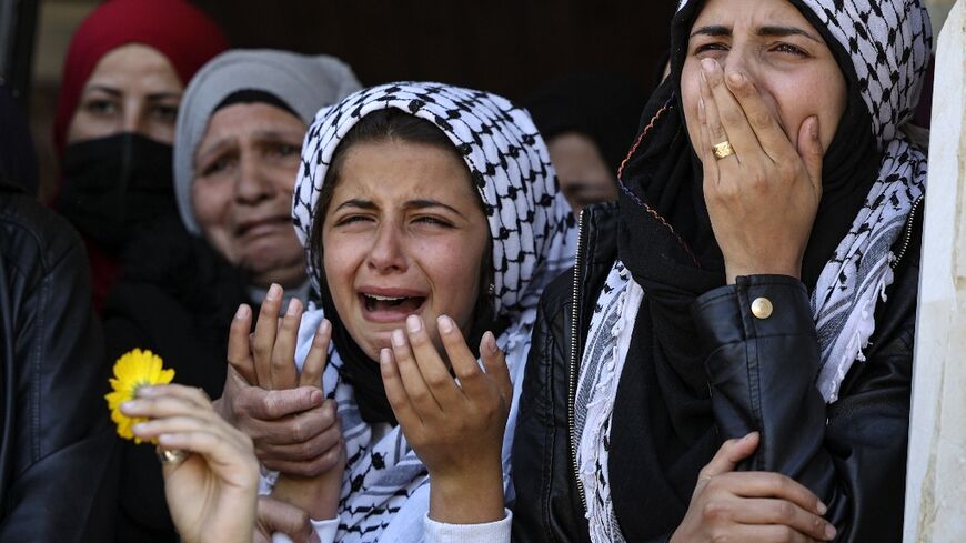 Mourners react during the funeral of a Palestinian shot during  clashes with Israeli troops in Silwad, north of the occupied West Bank city of Ramallah, on April 14, 2022