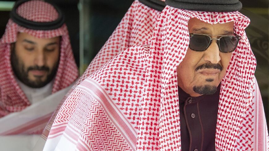 Saudi Arabia's King Salman Abdulaziz (R), accompanied by Crown Prince Mohammed bin Salman (L), on March 16, 2022