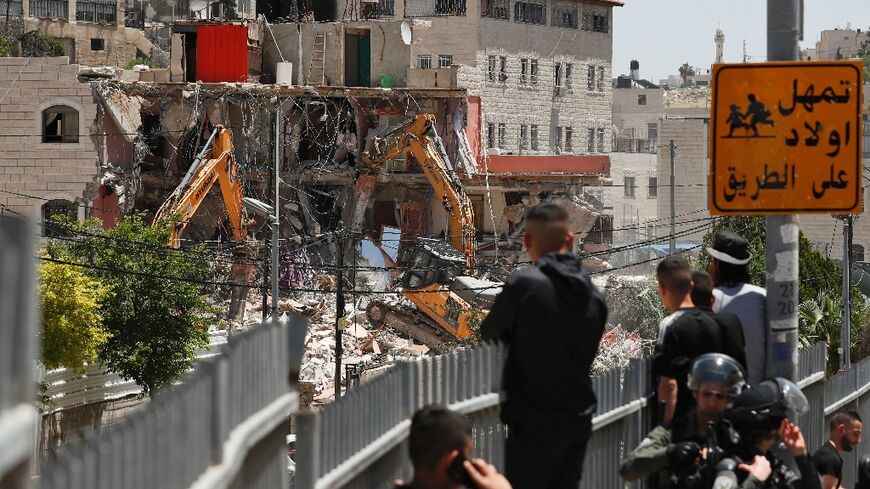 Israeli authorities usse heavy machinery to demolish a Palestinian house in the east Jerusalem neighbourhood of Silwan on May 10, 2022