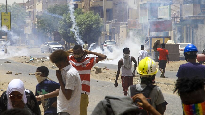 Sudanese demonstrators throw tear gas canisters back at security forces in the capital Khartoum on May 19, 2022 