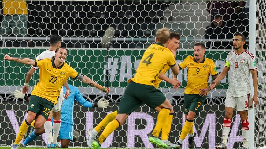 Ajdin Hrustic (C behind) scored a late winner to put Australia one victory away from a place at the World Cup