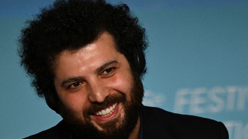 Iranian director Saeed Roustaee smiles during a press conference for his movie "Leila's Brothers" at this year's Cannes Film Festival