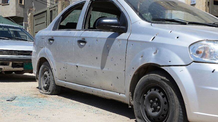 Cars parked outside the Turkish consulate in Iraq's main northern city of Mosul are peppered with shrapnel from the overnight rocket fire