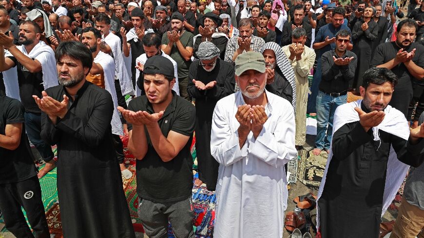 Supporters of Iraqi Shiite cleric Moqtada Sadr gather for the weekly Friday prayers during their vigil outside parliament in the capital Baghdad