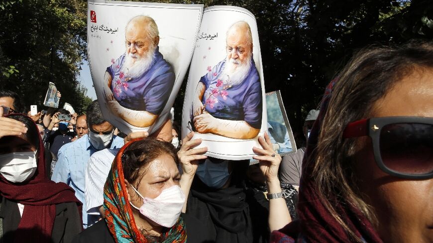 Iranians attend a funeral ceremony for Iranian poet Amir Hushang Ebtehaj, also known by his pen name H.E.Sayeh, outside the Vahdat hall in Tehran, on August 26 2022