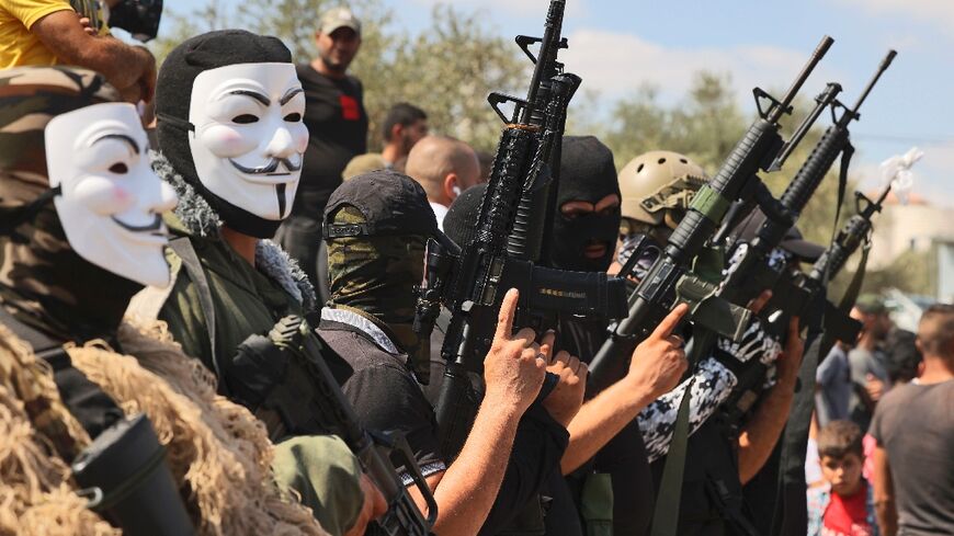 Masked gunmen attend the funeral of Palestinian teenager Uday Salah, killed in clashes with Israeli troops in the occupied West Bank