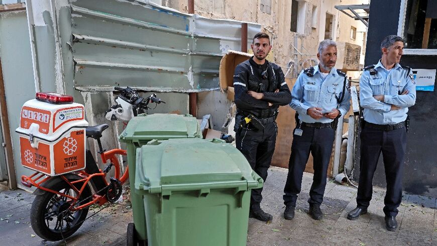 Police survey the spot in central Tel Aviv where Palestinian murder suspect Mousa Sarsour was found hanged in what Israeli media reported was an apparent suicide