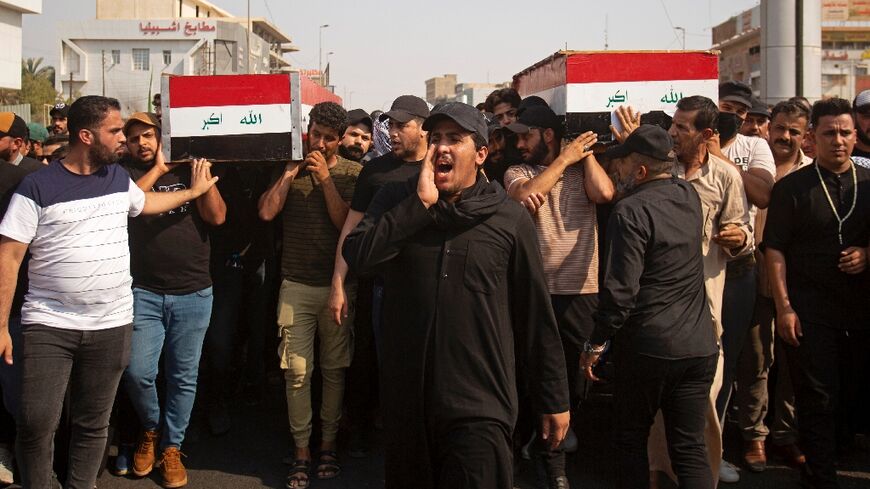 Iraqi mourners attend the funeral of two fighters from Saraya al-Salam, an armed faction linked to powerful Shiite cleric Moqtada Sadr, in the southern Iraqi city of Basra