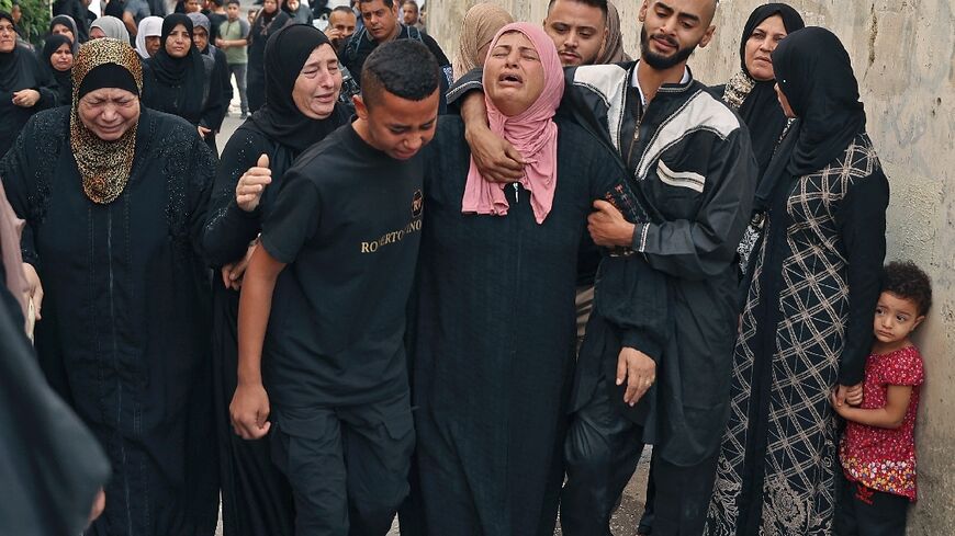 The mother (C) of Palestinian Mateen Debaya, killed early in the morning during an Israeli raid, mourns at his funeral in the flashpoint city of Jenin in the occupied West Bank