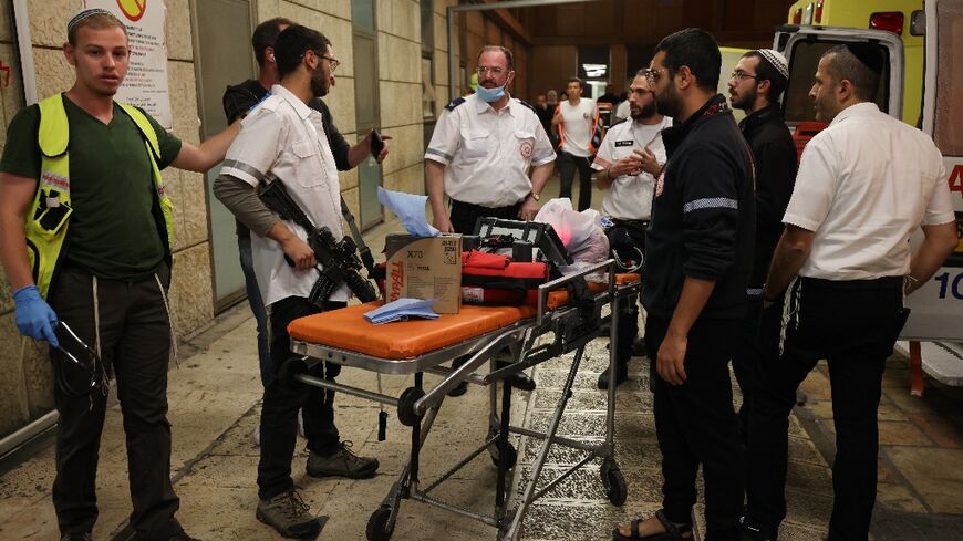 Israeli first responders gather outside the Hadassah Ein Kerem Hospital in Jerusalem following the attack in Hebron