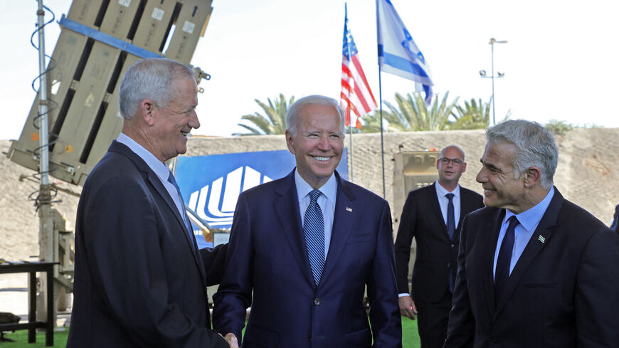 (L to R) Israel's Defence Minister Benny Gantz, US President Joe Biden and Israeli caretaker Prime Minister Yair Lapid, stand in front of Israel's Iron Dome defence system during a tour at Ben Gurion Airport near Tel Aviv, on July 13, 2022.