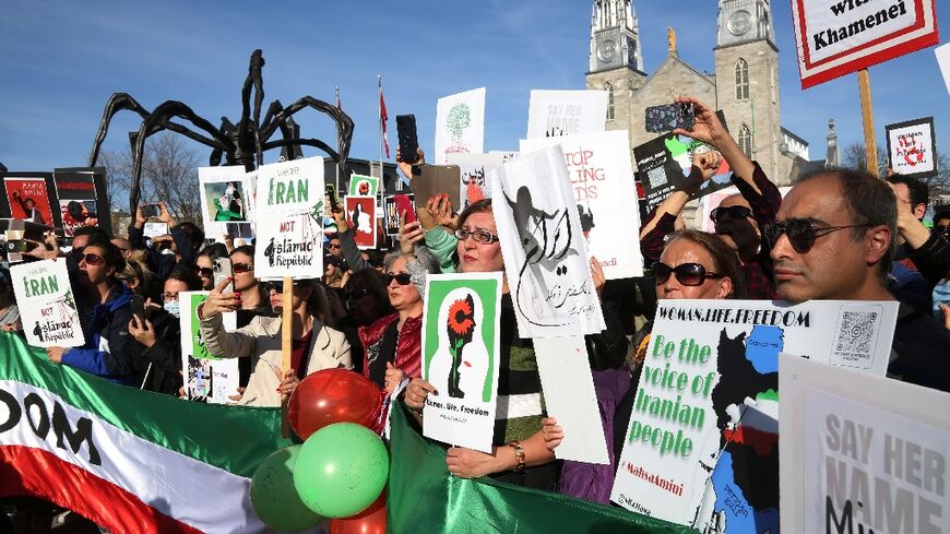 People rally in downtown Ottawa, Canada, in support of freedom for women in Iran in October