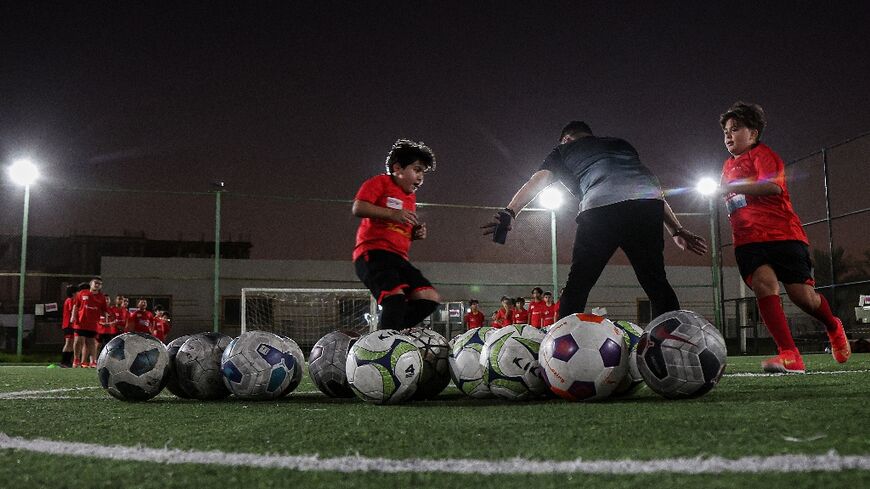 Children train at a football pitch in Qatar's capital Doha 