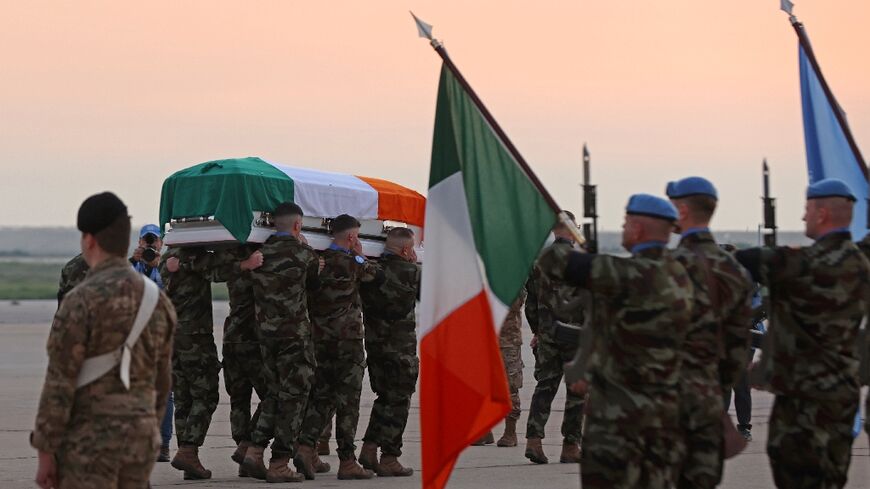 United Nations peacekeeping troops carry the coffin of Irish soldier Sean Rooney, who was killed on a UN patrol