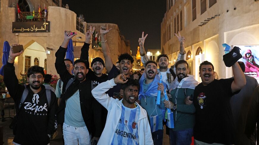 Supporters in Doha's Souq Wafiq celebrate Argentina's first goal of the World Cup final