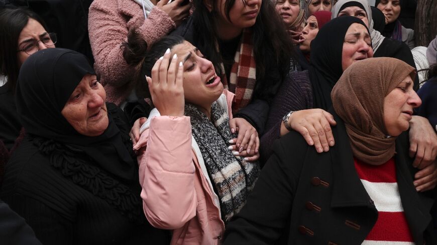 Mourners attend the funeral of Omar Khmour, 14, in Bethlehem's Dheisheh refugee camp in the occupied West Bank on January 16