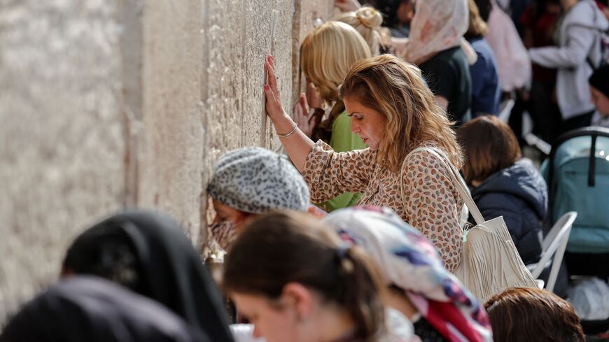 Jewish women pray at the women's section of the Western Wall in Jerusalem's Old City on November 17, 2021. (Photo by AHMAD GHARABLI/AFP via Getty Images)
