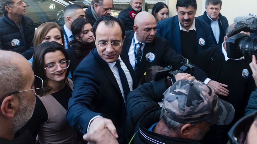 Former Cyprus foreign minister and presidential candidate Nikos Christodoulides greets supporters after casting his ballot for the presidential elections in the western Paphos district