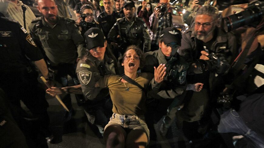 Security forces detain a protester near the premier's Jerusalem residence