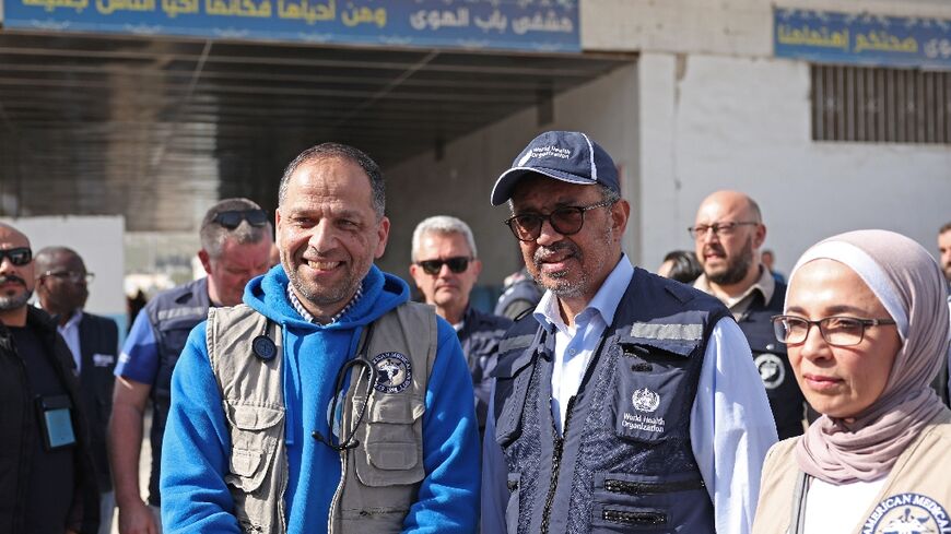 World Health Organisation chief Tedros Adhanom Ghebreyesus (C) visits a hospital run by the Syrian American Medical Society in Bab al-Hawa near the border with Turkey on March 1, 2023