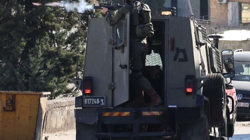 An Israeli soldier fires a projectile during clashes in the city of Nablus in the occupied West Bank