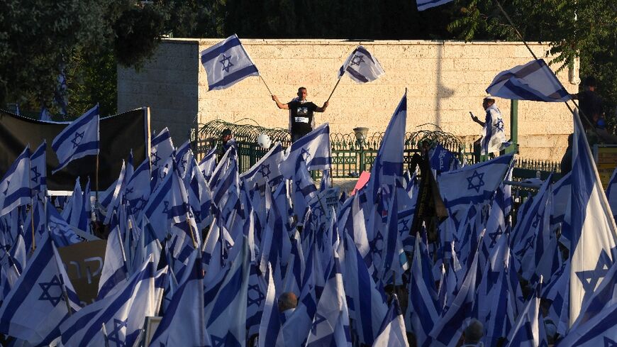 Pro-government protesters gather near Israel's parliament in Jerusalem on April 27, 2023 in support of the hard-right government's controversial push to overhaul the justice system 
