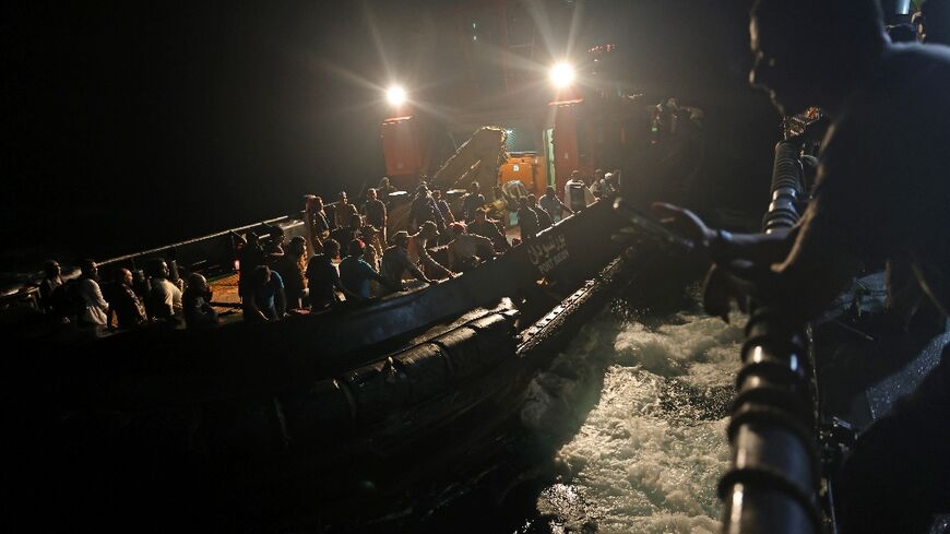 Before dawn, evacuees from Sudan's war boarded a tugboat which transported them out to a Saudi Arabian warship