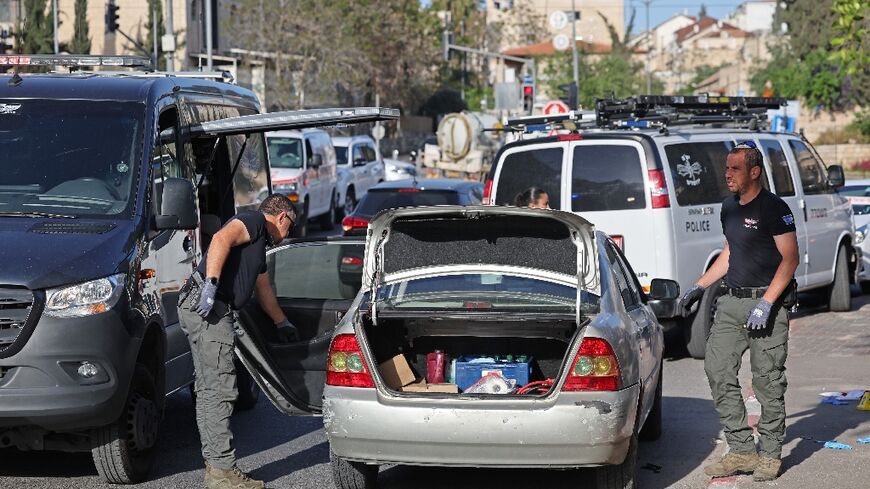 Israeli security forces inspect a vehicle following a shooting attack in the neighbourhood of Sheikh Jarrah in annexed east Jerusalem