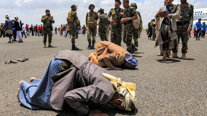 Released prisoners prayed on the tarmac at Sanaa airport