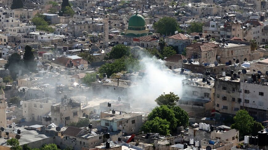 Smoke rises over the West Bank city of Nablus as Israeli troops carry out a deadly raid in the Old City