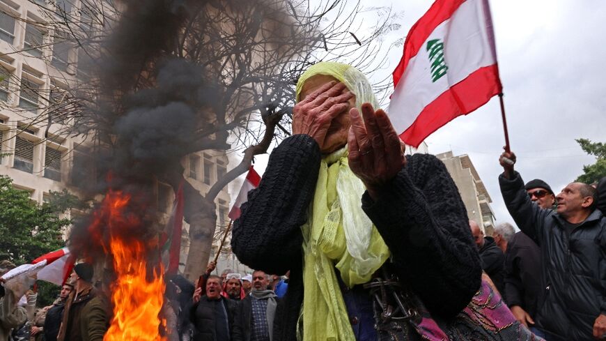 Protesters rally outside Lebanon's central bank headquarters in Beirut on March 30, 2023, demanding pension payments are adjusted to runaway inflation