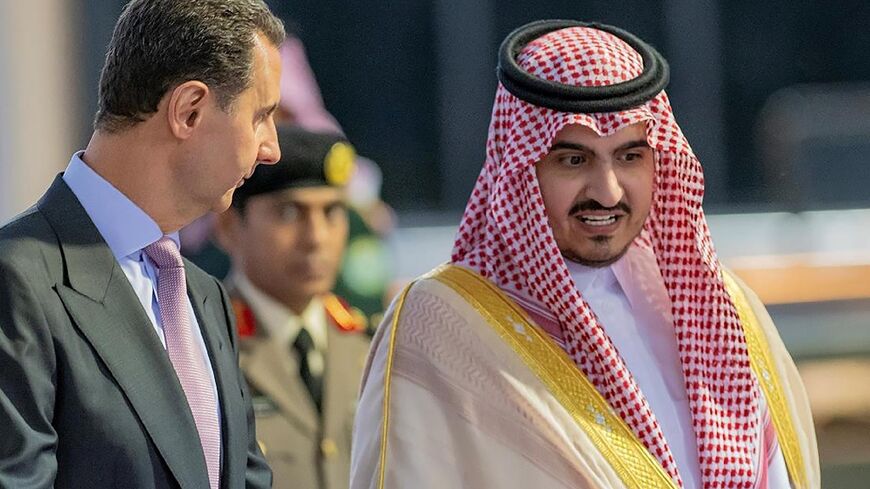 Syrian President Bashar al-Assad is welcomed by Mecca deputy governor Prince Badr bin Sultan as he arrives in the Saudi city of Jeddah for his first Arab summit in more than a decade of war