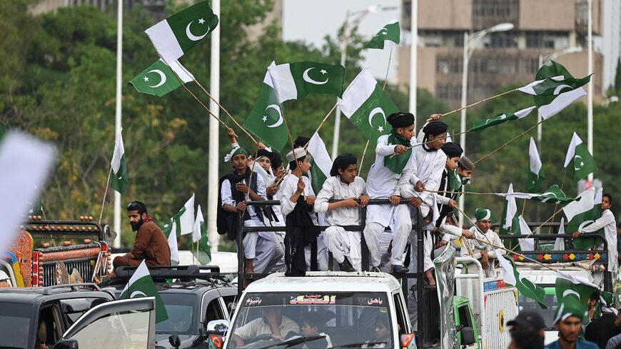 People carrying flags of Pakistan take part in a rally to show solidarity with Pakistan's army in Islamabad on May 17, 2023, after military installations were allegedly damaged by supporters of former Pakistan's prime minister Imran Khan following his arrest last week. 