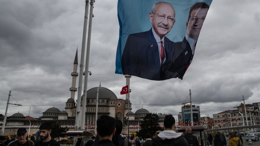 People walk past under the posters of Kemal Kilicdaroglu, the presidential candidate of the Main Opposition alliance and Turkey's President Recep Tayyip Erdogan at Taksim Square on May 10, 2023 in Istanbul, Turkey. On May 14th, Turkey’s President Erdogan will face his biggest electoral test as the country goes to the polls in the country’s general election. Erdogan has been in power for more than two decades -- first as prime minister, than as president -- but his popularity has recently taken a hit due to 