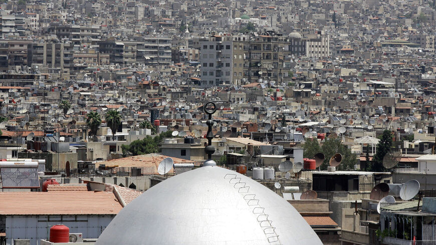The dome of a mosque is seen amongst the rooftops of home and apartment blocks in the Syrian capital, Damascus, on June 26, 2013.