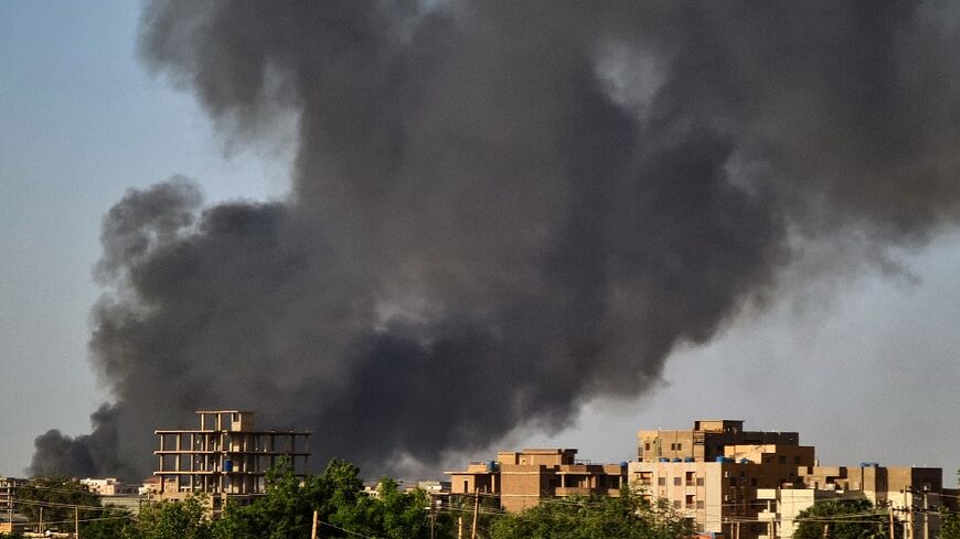 Smoke rises above buildings in Khartoum -- Sudan's war has continued unceasingly for more than a month