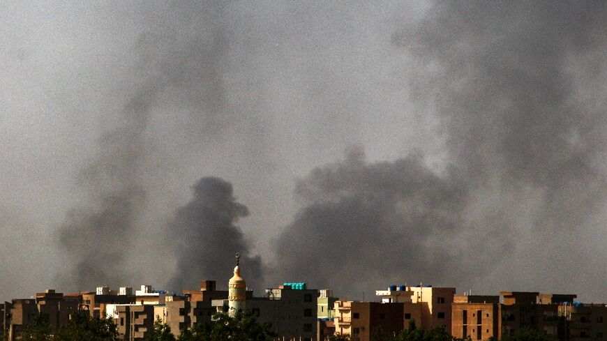 Smoke rises above buildings in Khartoum on the second day of the US- Saudi-brokered ceasefire as sporadic fighting continued