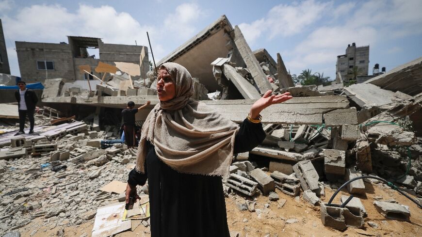 A member of the Palestinian Nabhan family speaks in front of the rubble of the family home, flattened in an Israeli air strike in Beit Lahiya, in the northern Gaza Strip